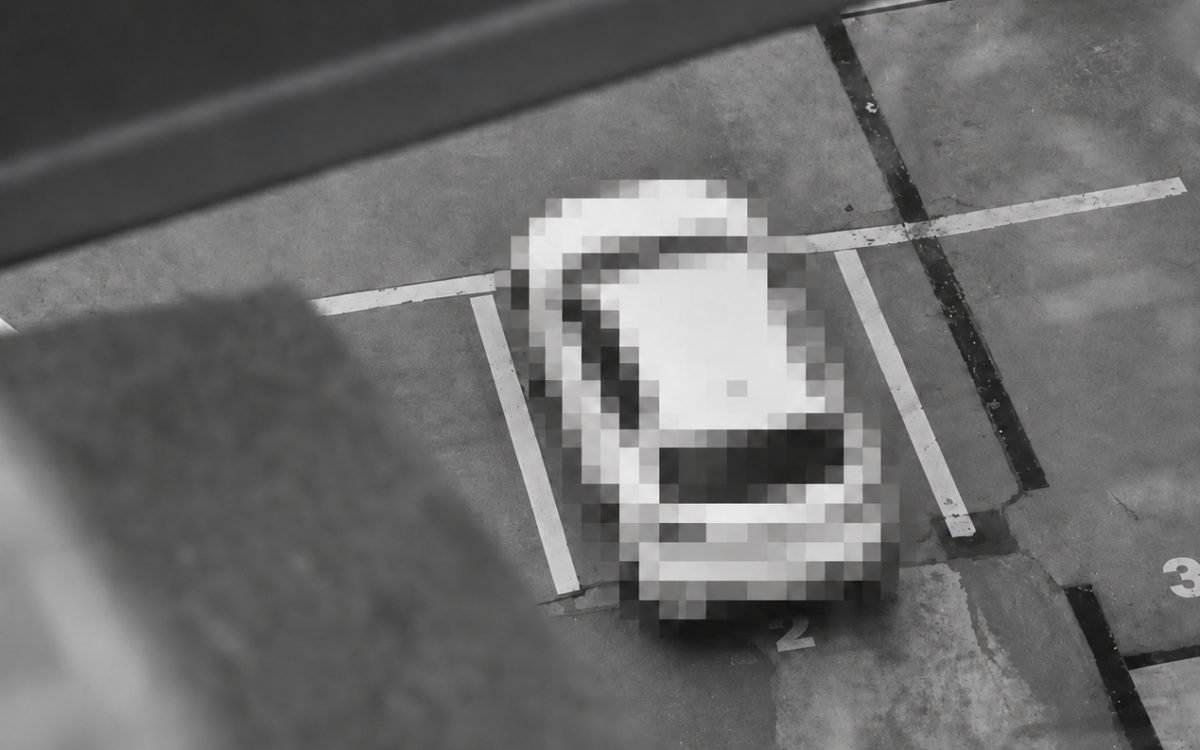 Shared car in a parking bay, pixelated so the brand can’t be identified
